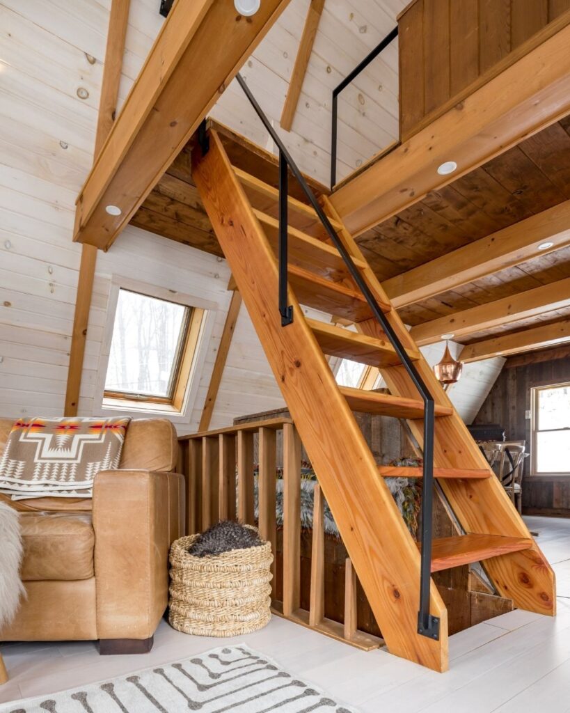Ladder style staircase goin up into a loft area
