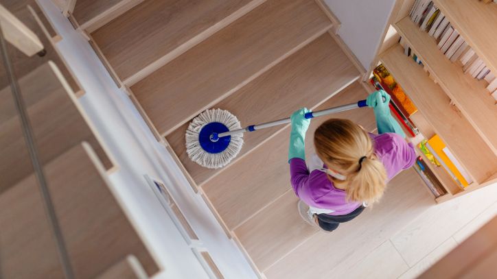 Woman mapping hardwood stairs with a microfiber mop