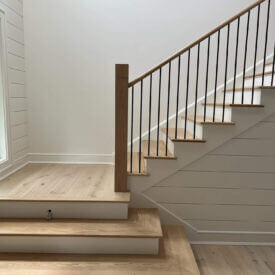 White Oak and white painted wooden L-shaped staircase