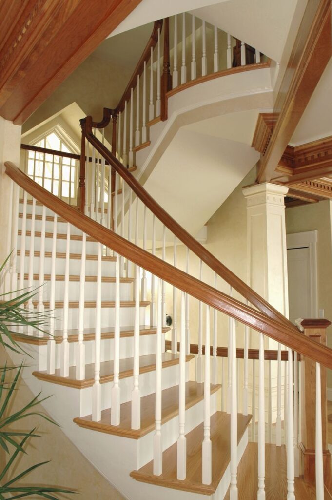 Custom Circular Switchback Staircase with red oak stained parts