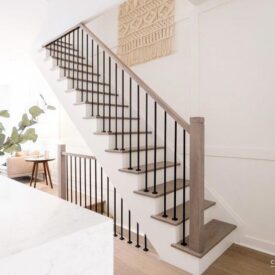 Modern staircase with stained and painted poplar wood parts and iron balusters