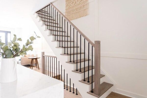 Modern staircase with stained and painted poplar wood parts and iron balusters
